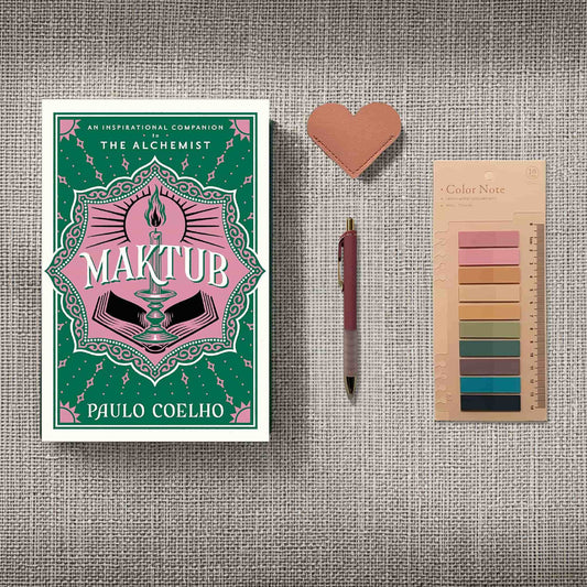 Dark academia inspired book flatlay with a green and pink copy of Maktub by Paulo Coelho and minimalist reading accessories on a textured cream surface.