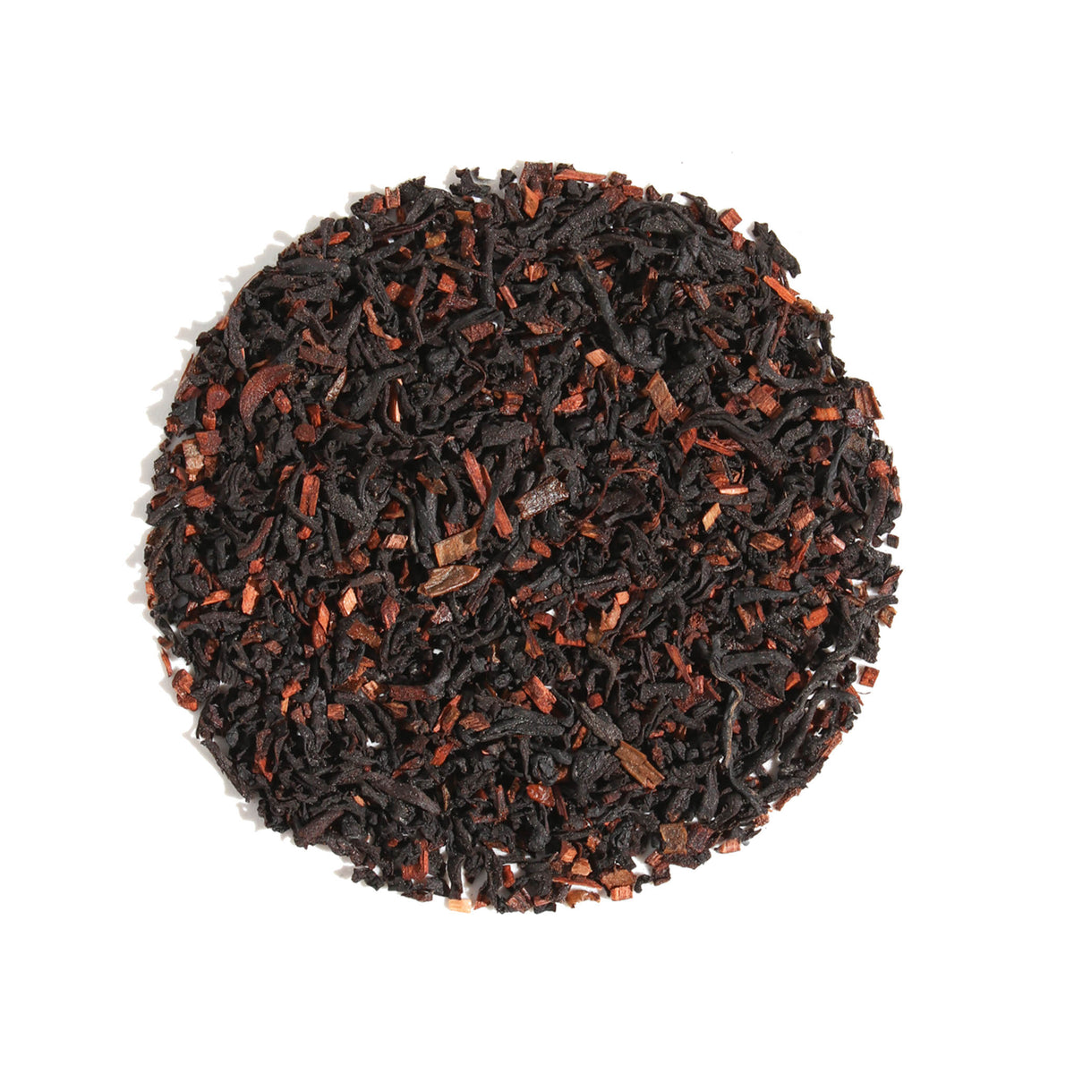 A close-up, overhead view of Plum Deluxe Eggnog Oolong Tea arranged in a neat circle against a white background. The blend features dark, tightly rolled oolong tea leaves generously speckled with warm, woodsy spice pieces.
