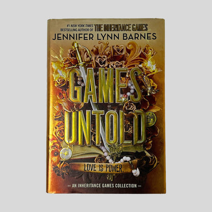 Front cover dust jacket of Games Untold by Jennifer Lynn Barnes in Like New hardcover condition, featuring gold metallic title lettering over warm amber and copper filigree art with roses, a sword, and pearl jewelry.