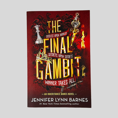 Front cover of The Final Gambit by Jennifer Lynn Barnes in Like New paperback condition, featuring metallic gold title lettering over crimson red artwork with chess pieces, dark roses, and a burning candle.