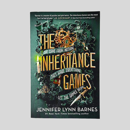 Front cover of The Inheritance Games by Jennifer Lynn Barnes in Like New paperback condition, featuring ornate green and gold key art with dark green roses.