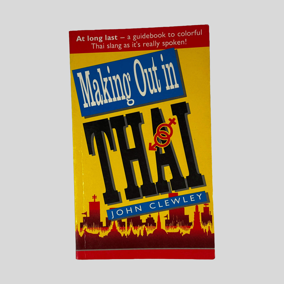 Front cover of Making Out In Thai by John Clewley, vintage 2001 BookSiam very good condition mass market paperback edition (Thai phrasebook & language reference).