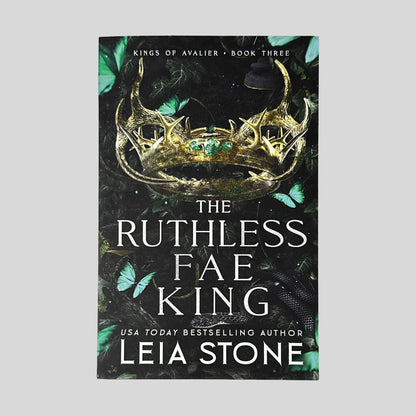 Front cover of The Ruthless Fae King by Leia Stone in Like New paperback condition, displaying Kings of Avalier Book Three header above a gold antler crown and teal butterflies.