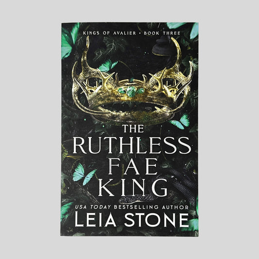 Front cover of The Ruthless Fae King by Leia Stone in Like New paperback condition, displaying Kings of Avalier Book Three header above a gold antler crown and teal butterflies.