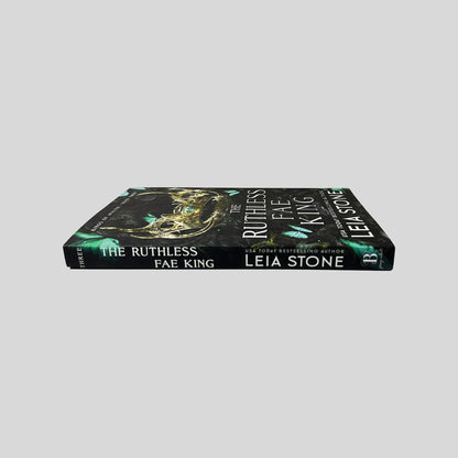 Unbroken spine view of The Ruthless Fae King paperback by Leia Stone displaying white title lettering, Kings of Avalier Book Three mark, and clean binding.