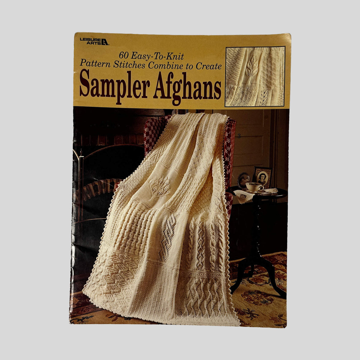 Front cover of 60 Easy-To-Knit Pattern Stitches Combine To Create Sampler Afghans by Leisure Arts, vintage very good condition softcover booklet (Knitting & craft guide).