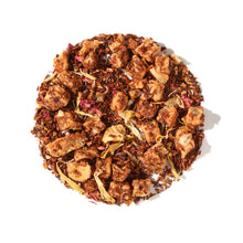 Loose leaf display of Plum Deluxe Peach Bellini Herbal Tea in a circle shape on a cream background.