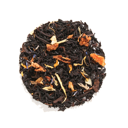 Loose leaf display of Plum Deluxe Peaches and Cream Oolong Tea in a circle shape on a cream background.