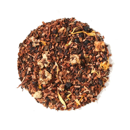 Loose leaf display of Plum Deluxe Self Care Apricot Elderberry Herbal Tea in a circle shape on a cream background.