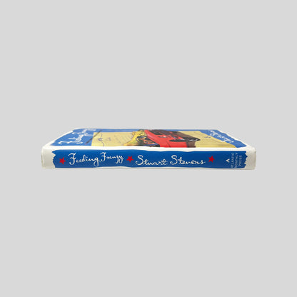 Spine view of Feeding Frenzy vintage hardcover edition in very good condition by Stuart Stevens.