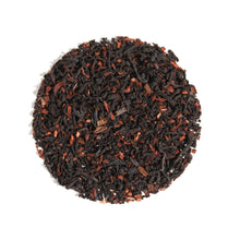 Top-down view of Vanilla Latte Cardamom Creme Black Loose Leaf Tea arranged in a circle on a white background, displaying dark black tea leaves blended with aromatic cardamom and warm spice pieces.